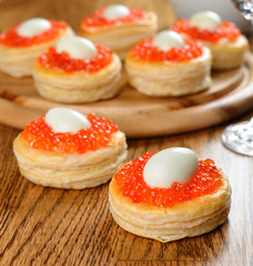 Appetizer with red caviar and quail eggs