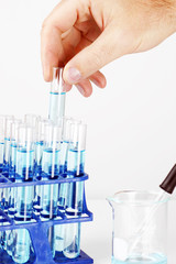 Man picking up sample in test tube