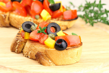 Italian bruschetta with tomatoes, pepper, olives and capers