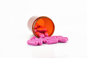 Pink capsule in prescription bottle