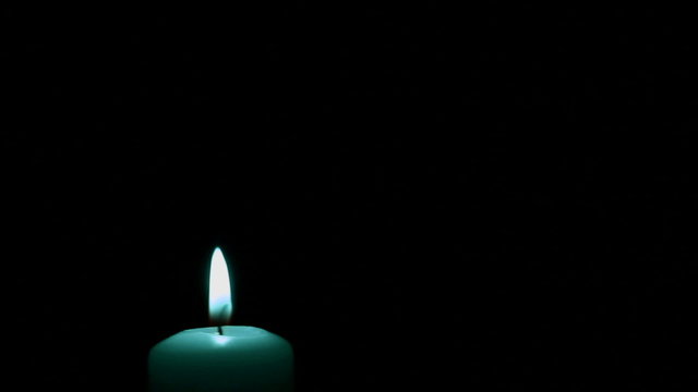 Lonely candle in the dark. Stabilized video