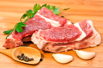 Raw beef with spices and vegetables on the cutting board