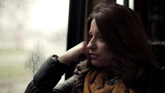 Pensive young woman riding the tram, steadicam shot