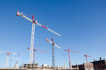 Cranes  on top of new condo construction