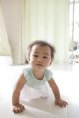 Fototapeta premium crawling of 10 month baby with funny face