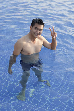 Man Standing In Water Pool Sign Victory Hand