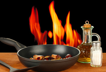 roasted chestnuts in the pan and decanter with oil, salt and