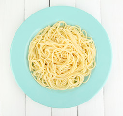 Italian spaghetti in plate on wooden table