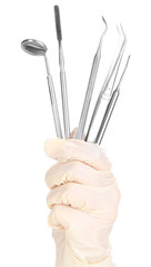 Dental tools in dentists hands isolated on white