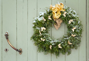 Green Christmas wreath on a wooden door