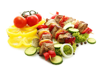 tasty grilled meat and vegetables on skewers, isolated on white