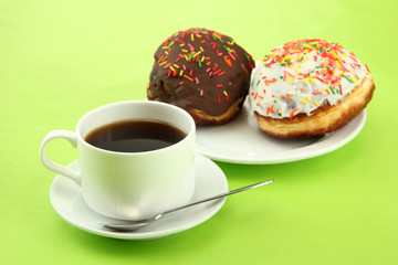 Tasty donuts on color plate on color background