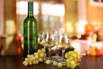 White wine in glass and bottle on room background