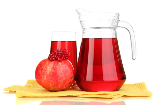 Full glass and jug of pomegranate juice and pomegranate