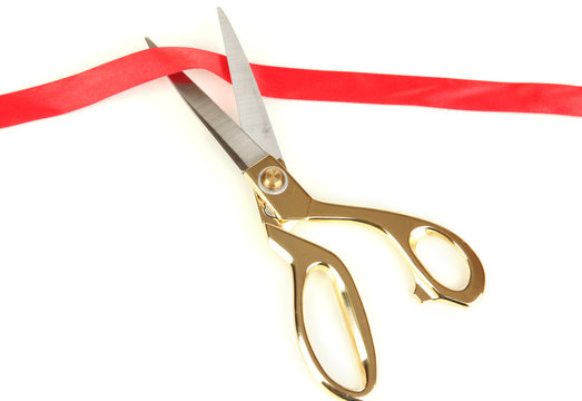 Cutting red ribbon isolated on white