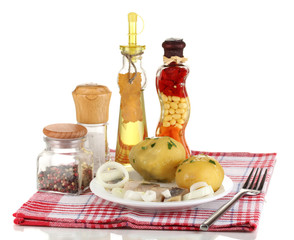 Dish of herring and potatoes on plate isolated on white