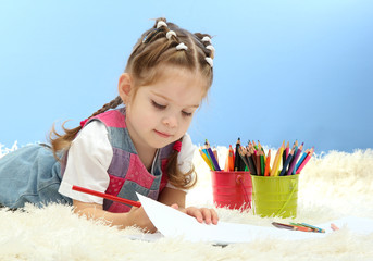 cute little girl playing with multicolor pencils,