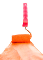 roller with orange paint isolated on white