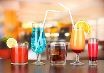 Several glasses of different drinks on bright background