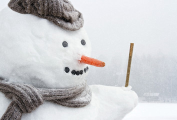 Happy frosty snowman outdoors in snowfall
