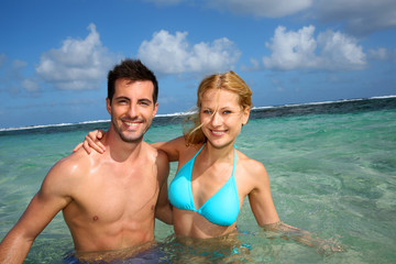 Cheerful couple swimming in a caribbean lagoon