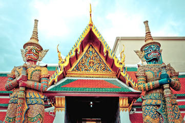 Fototapeta na wymiar Guardian statues and temple in Bangkok Grand Palace