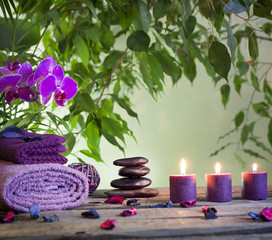 Spa still life with zen stones aromatic candles and orchids