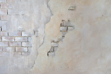 Brick wall with peeling plaster