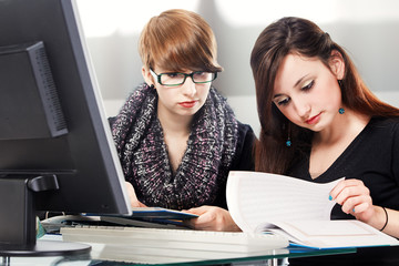 two schoolgirls doing homework