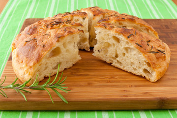 Homemade round Italian rosemary Focaccia bread sliced.
