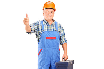 A manual worker holding tool box and giving a thumb up