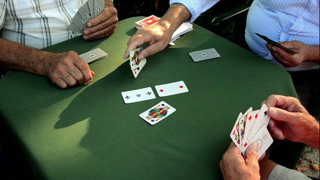 Seniors playing Scopa,  Italian card game