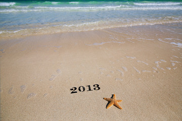2013 new year metal numbers on beach sea sand, shallow DOF
