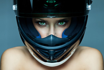 Sexy woman in helmet on blue background