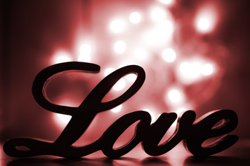 Love sign on red with light sparkles