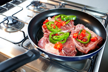 steak with red and green peppers in a pan