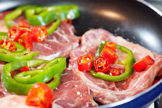 steak with red and green peppers in a pan