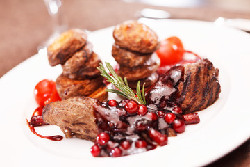 beef steak with potatoes and cranberry sauce