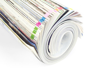Rolled up magazine, newspaper, with colorful index, white backgr