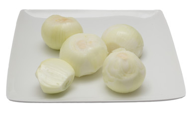 peeled onion in a dish on a white background