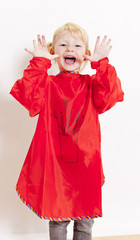 little girl wearing painting apron