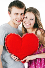 Beautiful smiling couple with red heart. Valentine's day