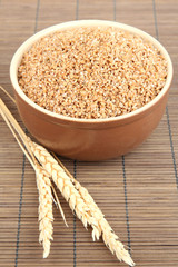 Brown bowl full of wheat bran