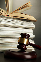 gavel and old papers on grey background
