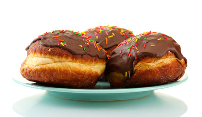 Tasty donuts on color plate isolated on white