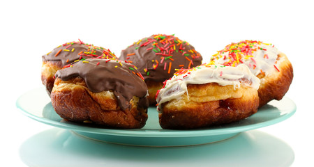 Tasty donuts on color plate isolated on white