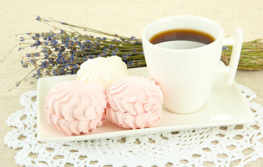 Marshmallows on plate on light background