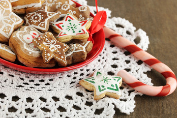 Christmas treats on plate on wooden table close-up