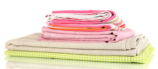 Pile of different fabrics isolated on white