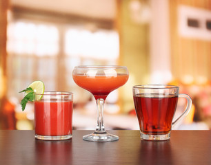 Several glasses of different drinks on bright background